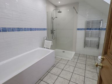 A bathroom with a bathtub and shower at Red Screes in Ambleside