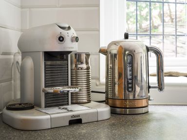 A countertop with a Nespresso coffee machine and a Dualit electric kettle near a window at Fellside Lodge in Bowness-On-Windermere