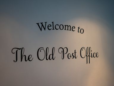 A wall with the words Welcome to The Old Post Office