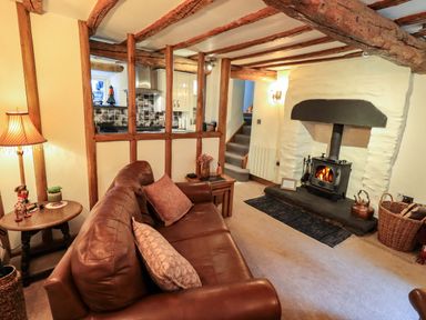 A living room with a sofa and fireplace at Fellside Cottage Bowness-On-Windermere
