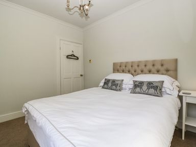 A bedroom with a double bed and bedside table at 23 Daniel Street in Bath