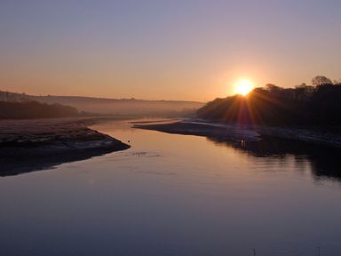 A river with trees on both sides at sunrise at Horseshoe Cottage in Hartland