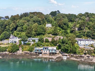 A view of houses on a hillside by the water at Afallon in Menai Bridge