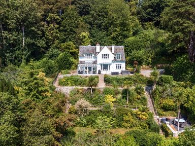 A house surrounded by greenery with a garden at Afallon in Menai Bridge