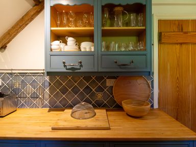 A kitchen with cabinets and kitchenware at Carrows Stable Morwenstow