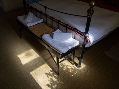 A bedroom with towels on a bench at Carrows Stable Morwenstow