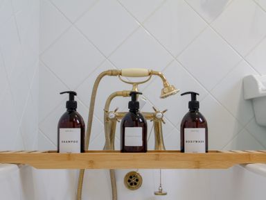 A bathtub with shampoo, conditioner, and bodywash at Carrows Stable in Morwenstow