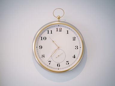 A wall clock with black numbers and gold trim on a white wall at Craig Cottage in Bowness-On-Windermere