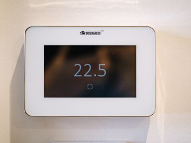 A digital thermostat on a wall displaying 22 5 degrees at Craig Cottage in Bowness-On-Windermere