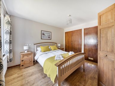 A bedroom with a bed and a nightstand at Tyn Y Ffynnon in Betws-Y-Coed