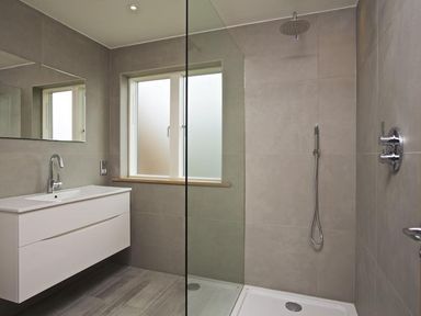 A bathroom with a floating vanity basin and a walk in shower at 3 The Drive Hillfield Village Dartmouth