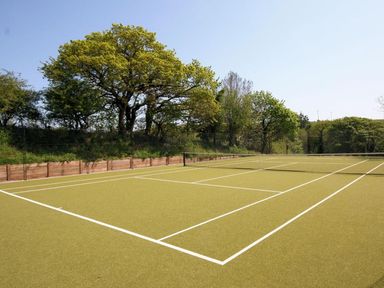 An outdoor tennis court surrounded by trees at 3 The Drive Hillfield Village in Dartmouth