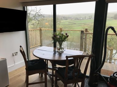 A dining room with a table and chairs at The Sett on the Wharfe in Skipton