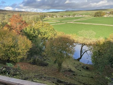 A view of a river and trees at The Sett on the Wharfe in Skipton