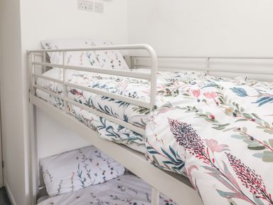 A bunk bed with floral patterned bedding in a bedroom at Sparrow Cottage in Keswick