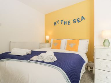 A bedroom with a bed and bedside table at 76A Mackworth Road in Porthcawl