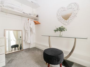 A dressing room with a table and mirror at 76A Mackworth Road in Porthcawl
