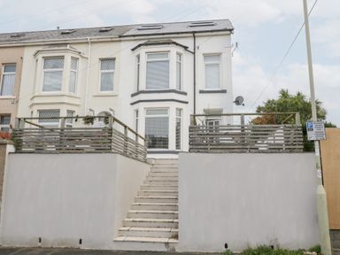 A house with a balcony and stairs at 76A Mackworth Road Porthcawl
