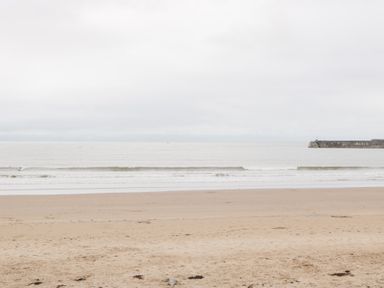 A beach with sand and water at 76A Mackworth Road in Porthcawl