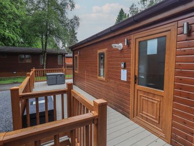 An outdoor area featuring a wooden lodge and decking at Ridgway Lodge Calgarth 40, White Cross Bay near Windermere