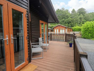 An outdoor area with chairs and doors at Rydal Lodge in Grasmere 24, White Cross Bay near Windermere