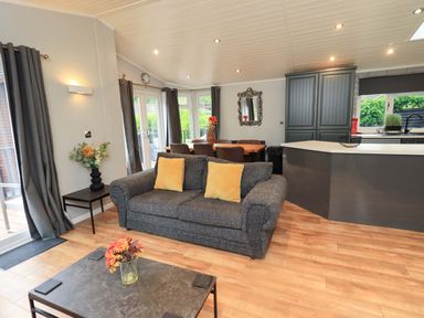 A living room with a sofa and coffee table at Rydal Lodge Grasmere 24, White Cross Bay near Windermere