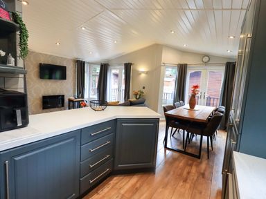 A kitchen with a dining area and seating at Rydal Lodge Grasmere 24, White Cross Bay near Windermere