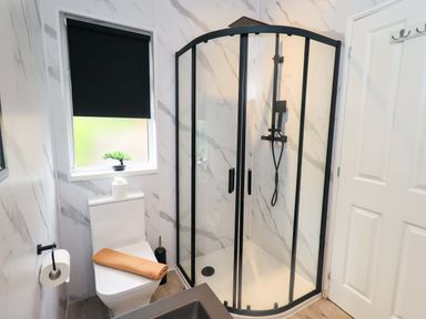 A bathroom with a shower and toilet at Rydal Lodge, Grasmere 24, White Cross Bay near Windermere