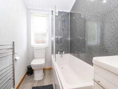 A bathroom with a bathtub shower combination toilet and vanity at Lakes Lodge Keswick Court 3 White Cross Bay near Windermere