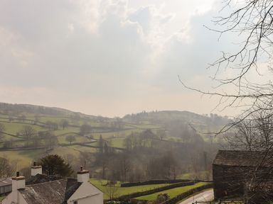A rural landscape with fields divided by stone walls houses and trees at Ramblers' Rest Lodge Pinewood 22 Limefitt Park near Windermere