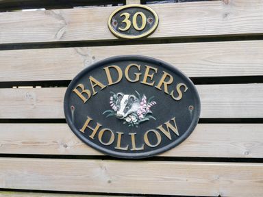 A sign that reads BADGERS HOLLOW with number 30 at Badgers Hollow Lodge, Grasmere 30, White Cross Bay near Windermere