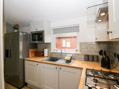 A kitchen with appliances and counter space at Badgers Hollow Lodge Grasmere 30, White Cross Bay near Windermere