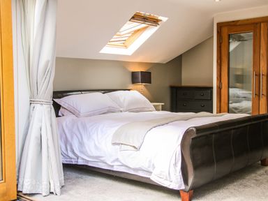 A bedroom with a double bed under a skylight window and a dresser at Sunnyside in Bircher Common near Yarpole