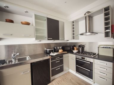 A kitchen with stainless steel sink stove oven microwave and cabinets at Fairhaven in Dartmouth