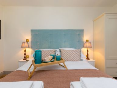 A bedroom with a bed and tray of tea at Scilly Stack in St Just