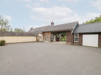 An outdoor area with a building and garage at Tynewydd Fields, Cross Inn
