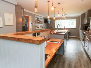 A kitchen with a sink and cooking hob at Tynewydd Fields in Cross Inn
