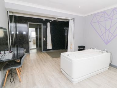 A bathroom with a bathtub and a shower at Tynewydd Fields in Cross Inn