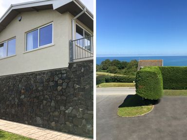 A house with stone and plaster walls and a patio area next to a road with trimmed hedges and a view of the sea at Aelwyd Y Don in Tresaith