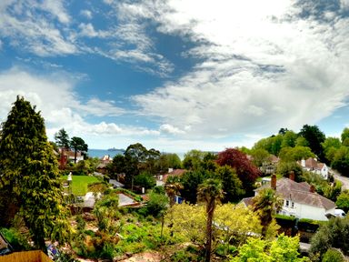 A coastal residential area with houses trees and ocean view at Harbour Lights in Torquay