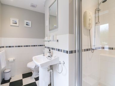 A bathroom with a sink toilet and shower at Farm View Lodge in Painswick