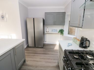 A kitchen with cabinets and appliances at Westwinds Tenby