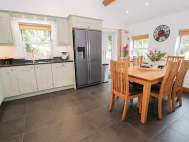 A kitchen with a table and chairs at Greffyn in Betws-Y-Coed