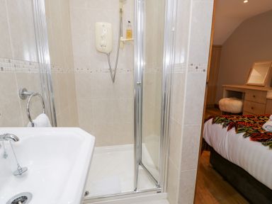 A bathroom with a shower and bathtub at Greffyn in Betws-Y-Coed