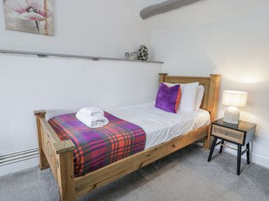 A bedroom with a single bed and lamp at Orsedd Wen Farmhouse in Betws-Y-Coed