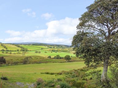 A scenic view of hills and fields at Orsedd Wen Farmhouse in Betws-Y-Coed