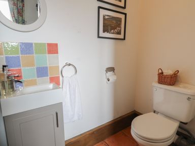 A bathroom with a sink and toilet at Orsedd Wen Cottage in Betws-Y-Coed