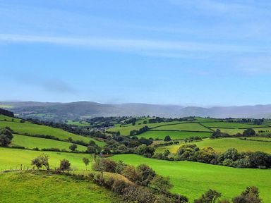 A landscape view of fields and hills at Orsedd Wen Cottage Betws-Y-Coed