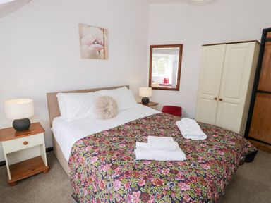 A bedroom with a bed and lamp at Cwm in Capel Curig