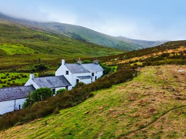 A cottage on a grassy hill at Cwm in Capel Curig